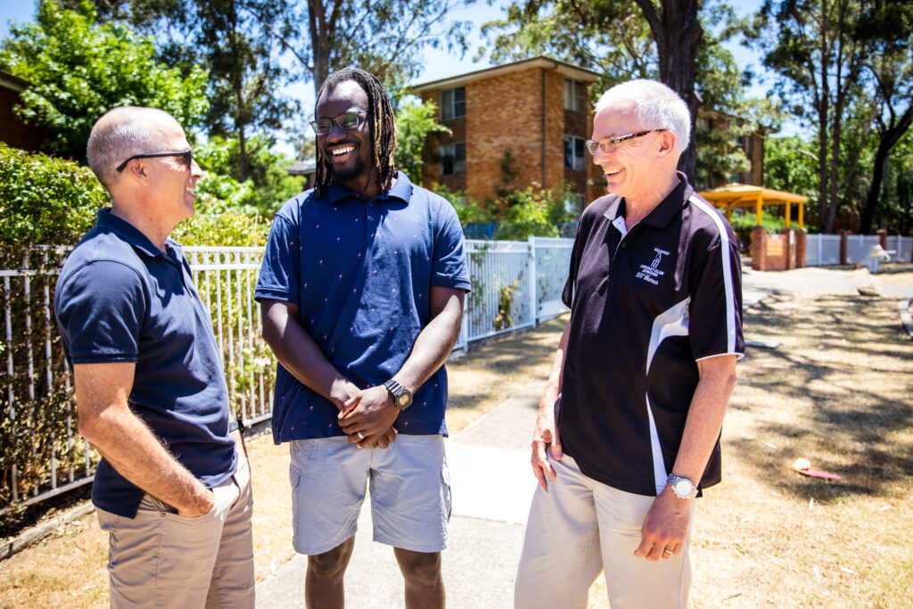 Ministry intern talking to two staff of The Well Training